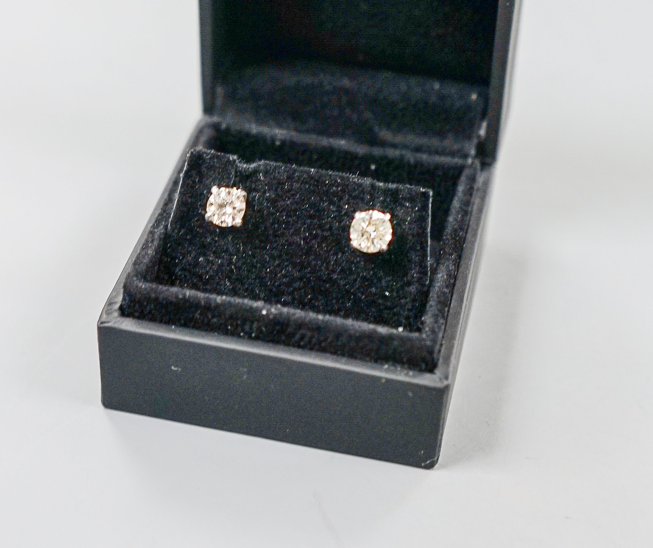 A pair of 750 white metal and solitaire diamond ear studs, gross weight 2.3 grams